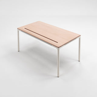 Close-up of a wood desk surface in a refined workspace setting