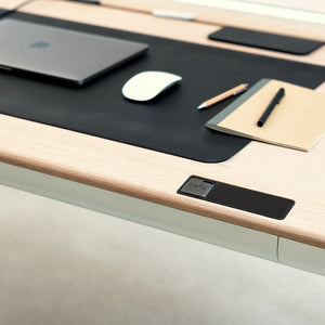 Close up view of Tenon desk with moss deskmat