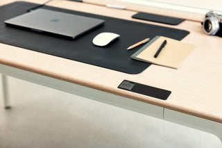 Close up view of Tenon desk with moss deskmat