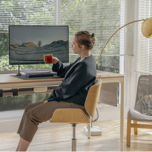 Woman Drinking Out of Mug at Desk