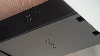 Close-up of a device with USB ports and Belkin branding on a wooden surface.