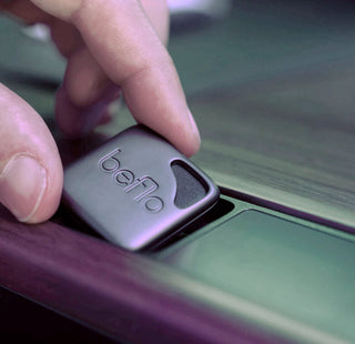 Hand placing a beflo aroma diffuser with onto the Tenon desktop slot.