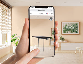 a hand holding phone to play AR of smart desk